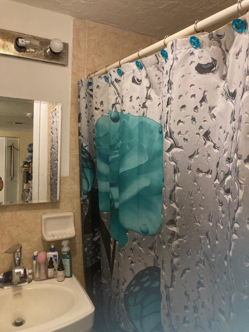 120 West 22nd Street Riviera Beach, FL 33404 - Photo 3 of 7 a bathroom with a sink and a mirror