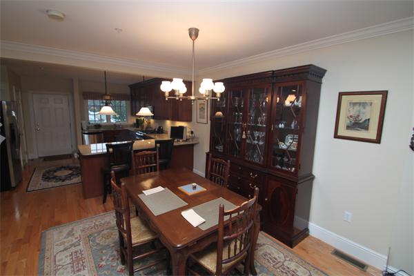 49 Intrepid Circle, Unit 49 Marblehead, MA 01945 - Photo 3 of 12 a view of a dining room with furniture and chandelier