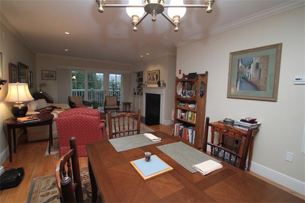 49 Intrepid Circle, Unit 49 Marblehead, MA 01945 - Photo 4 of 12 a living room with furniture a flat screen tv and a dining table