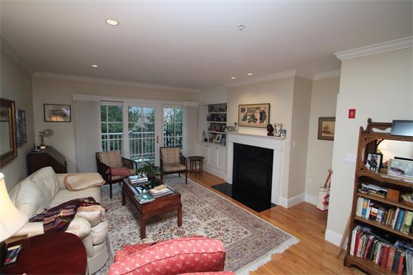 49 Intrepid Circle, Unit 49 Marblehead, MA 01945 - Photo 5 of 12 a living room with furniture fireplace and book shelf
