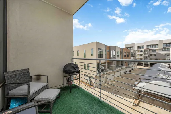 a view of a chairs and table in the balcony