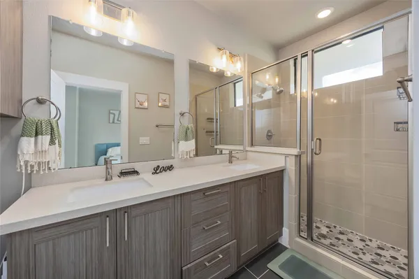 a bathroom with a double vanity sink mirror and double