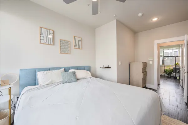 a bedroom with a large bed and a chandelier