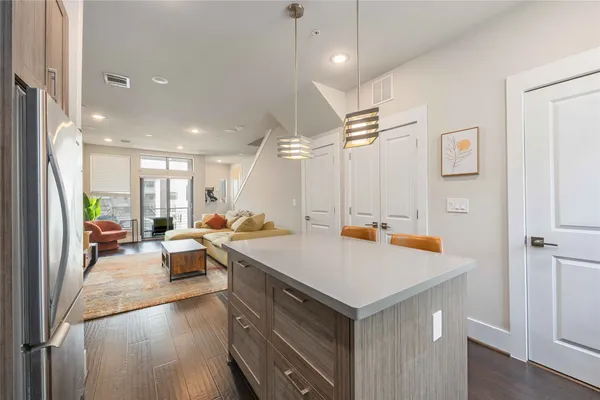 a view of kitchen island a sink a table and chairs