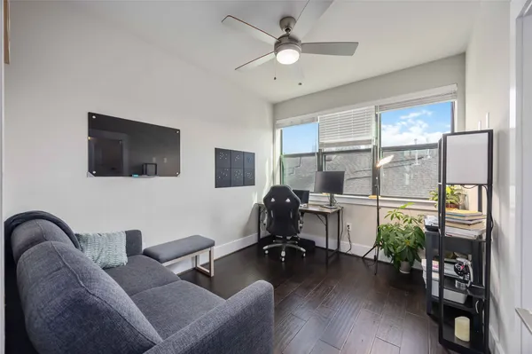 a view of a livingroom with workspace and a window