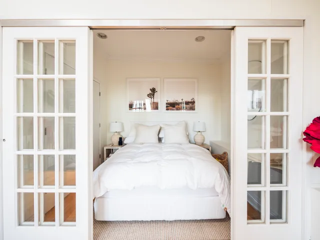 a bedroom with furniture and a flat screen tv