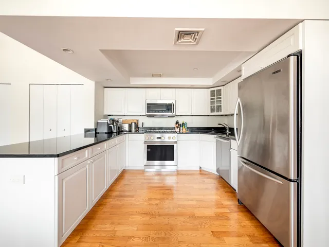 a kitchen with a refrigerator a sink and dishwasher