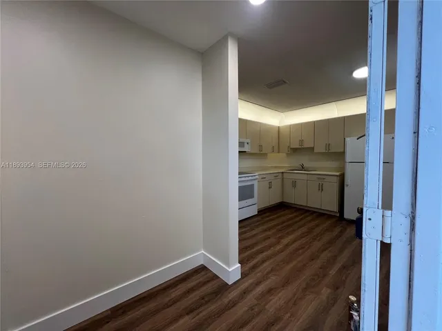 a view of kitchen with wooden floor