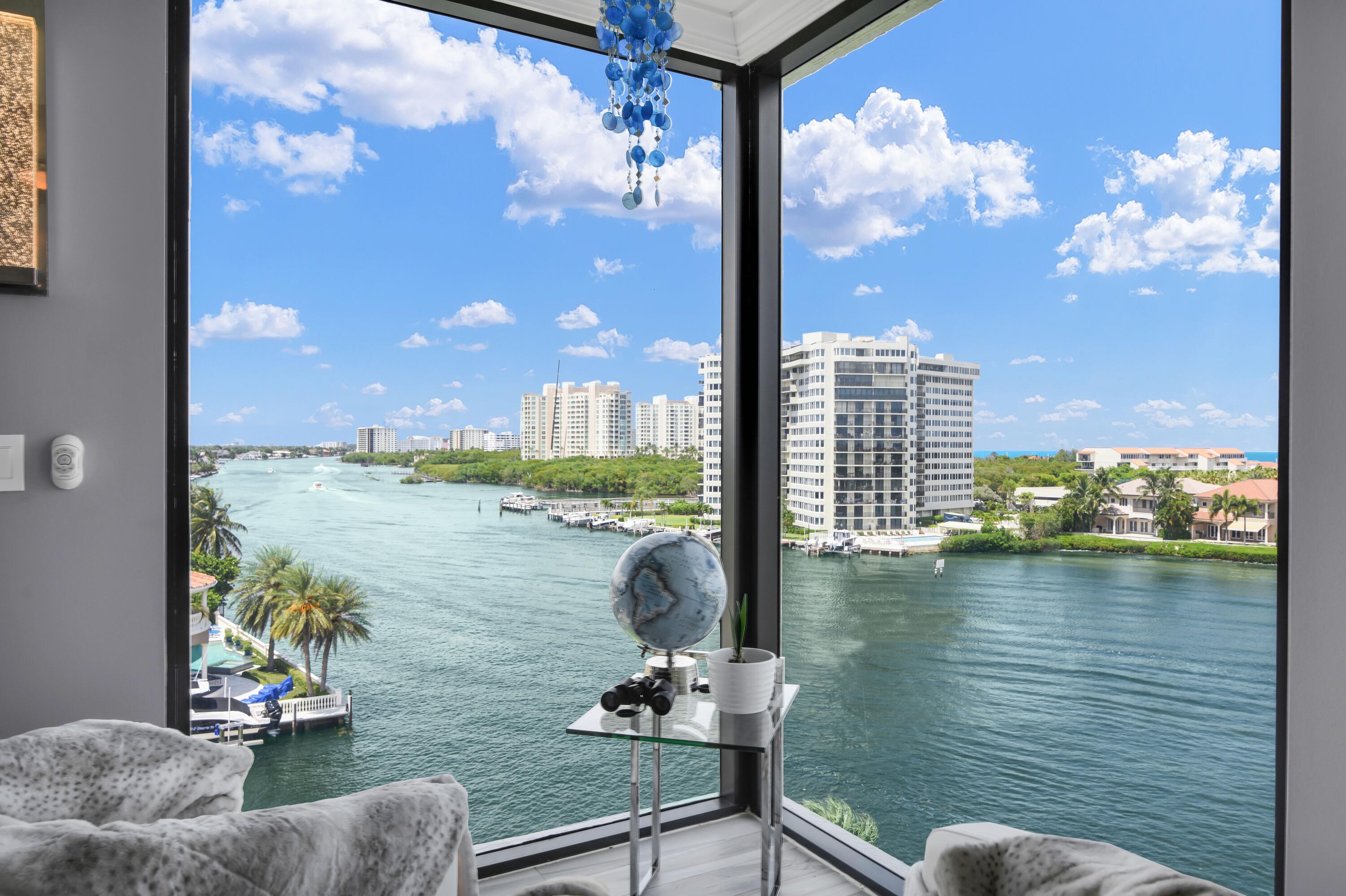 a view of a lake from a balcony with dining room