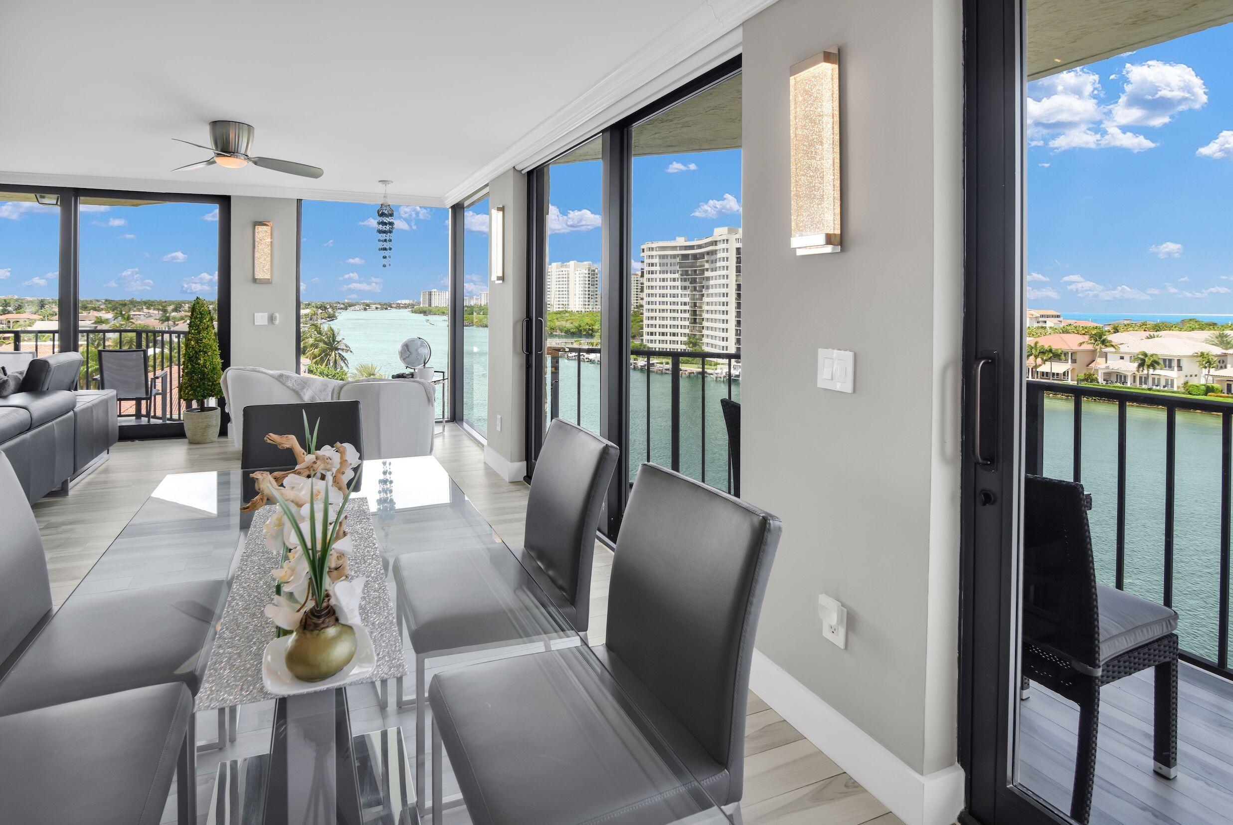 899 Jeffery Street, Unit 714 Boca Raton, FL 33487 - Photo 12 of 51 a view of a dining room with furniture a chandelier and wooden floor