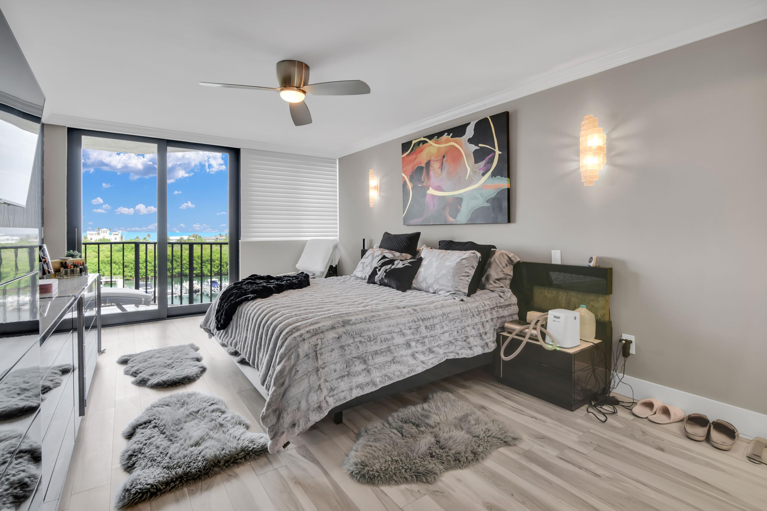 899 Jeffery Street, Unit 714 Boca Raton, FL 33487 - Photo 16 of 51 a bedroom with a bed and glass walk in closet