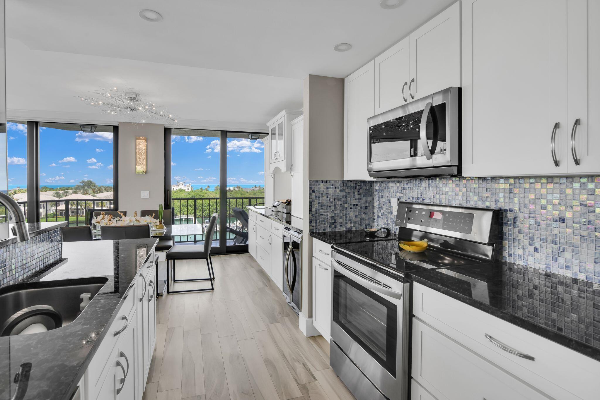 899 Jeffery Street, Unit 714 Boca Raton, FL 33487 - Photo 4 of 51 a kitchen with a stove a sink and a microwave