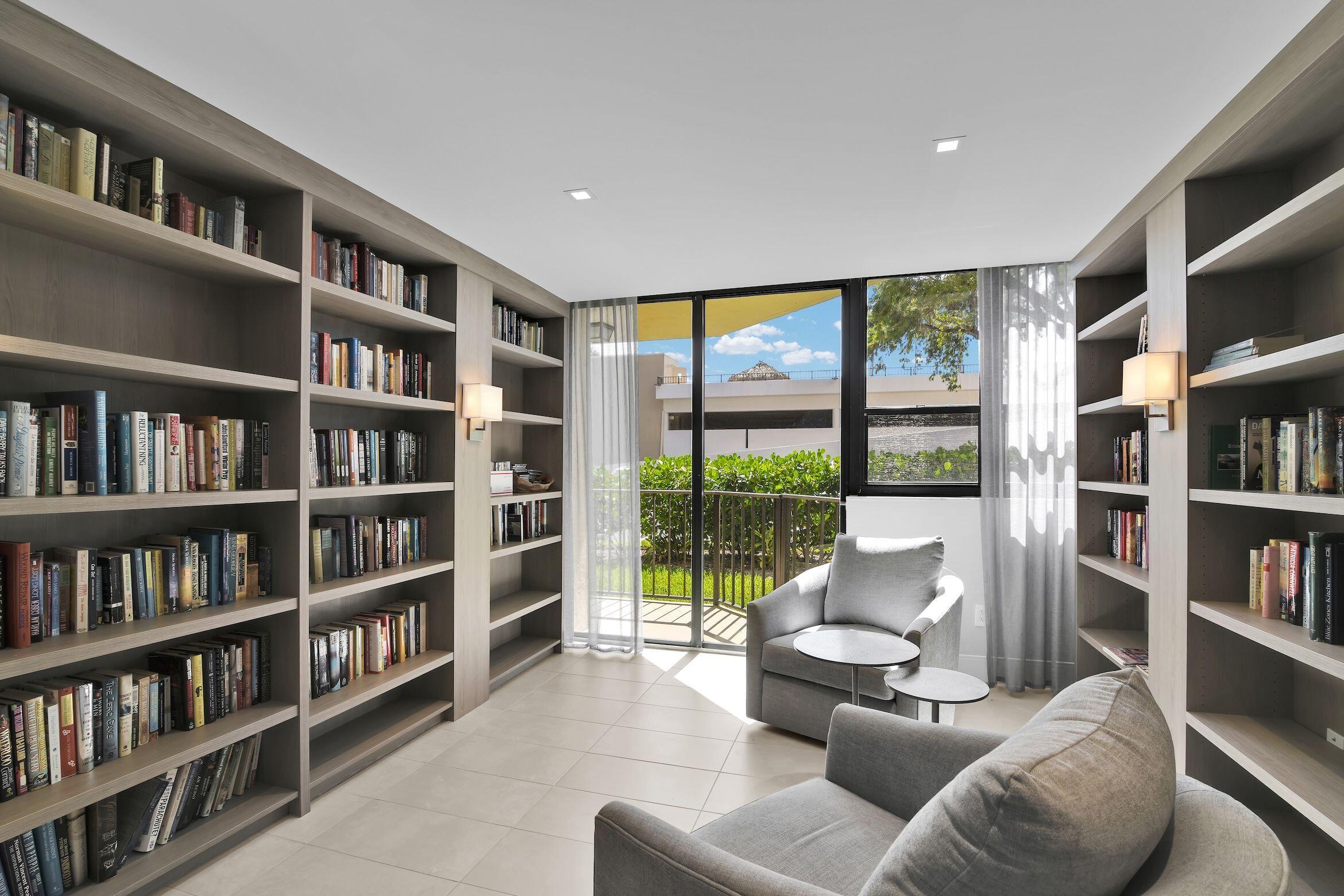 899 Jeffery Street, Unit 714 Boca Raton, FL 33487 - Photo 46 of 51 a living room with furniture and a book shelf