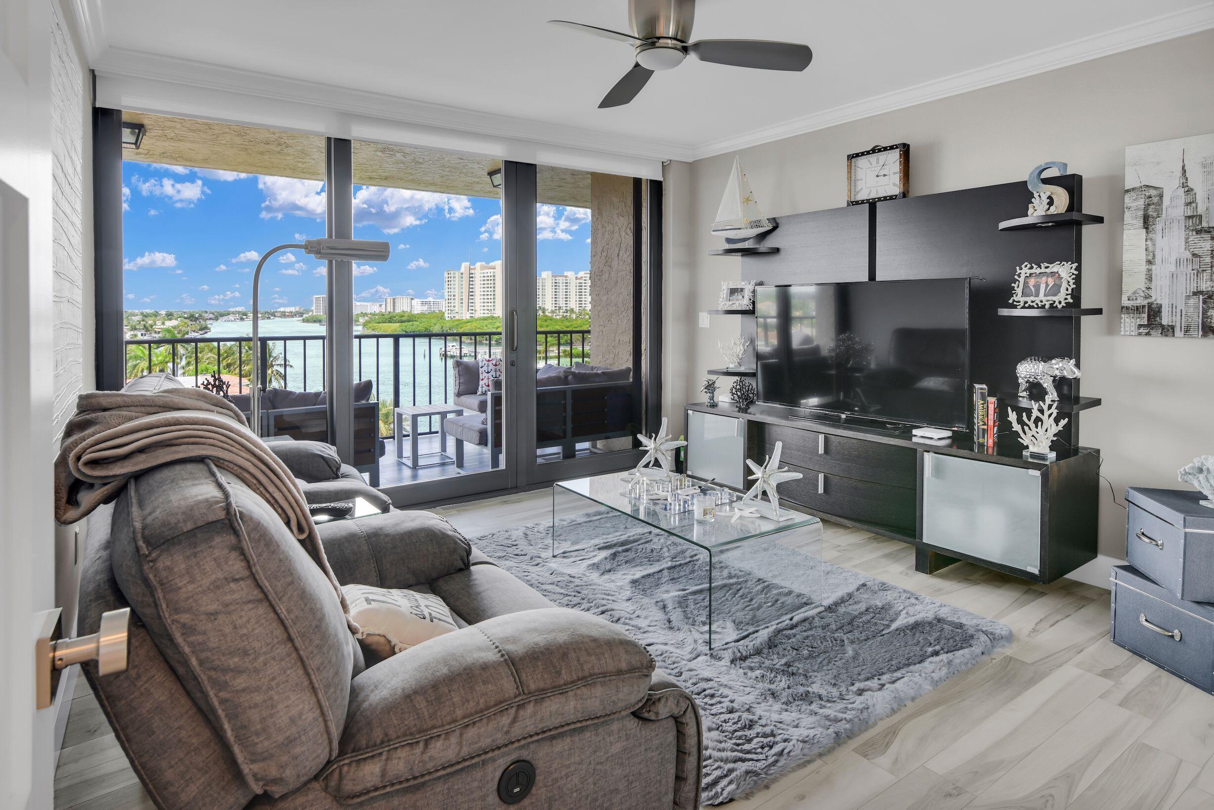 899 Jeffery Street, Unit 714 Boca Raton, FL 33487 - Photo 9 of 51 a living room with furniture a flat screen tv and a large window