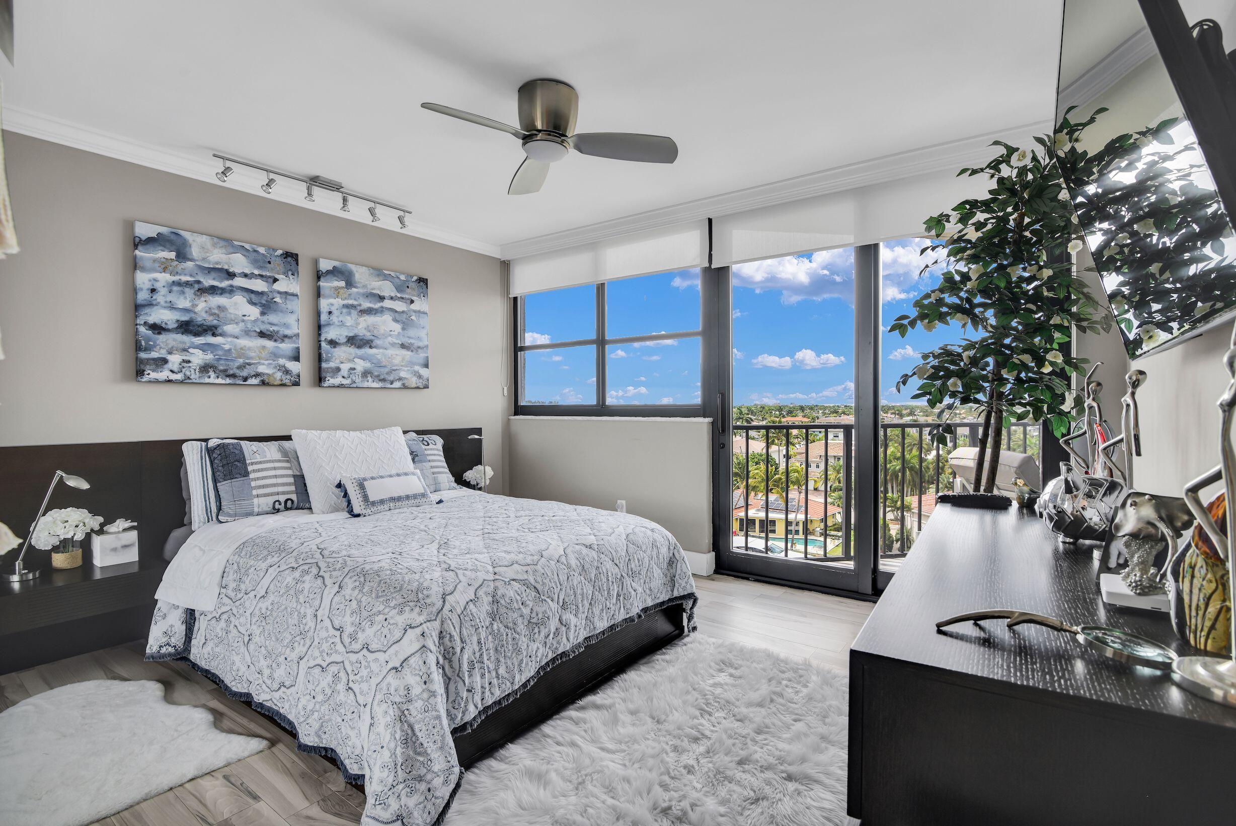 899 Jeffery Street, Unit 714 Boca Raton, FL 33487 - Photo 10 of 51 a bedroom with a large bed and a chandelier