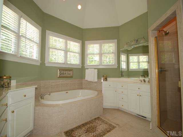 1005 Farnsworth Road Wake Forest, NC 27587 - Photo 13 of 25 The picture perfect master bath has a whirlpool bath, his and hers vanity areas and as eparate shower. Master Bath/Spa