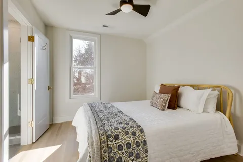 a bedroom with a large bed and a window