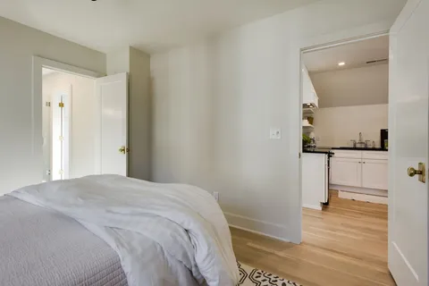 a bedroom with a bed and a view of bathroom
