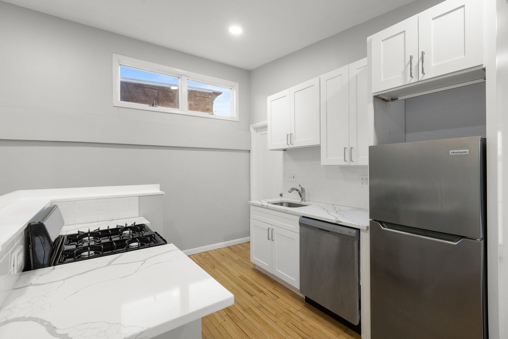 431 7th Street, Unit 2B Union City, NJ 07087 - Photo 7 of 16 a kitchen with a refrigerator and a stove