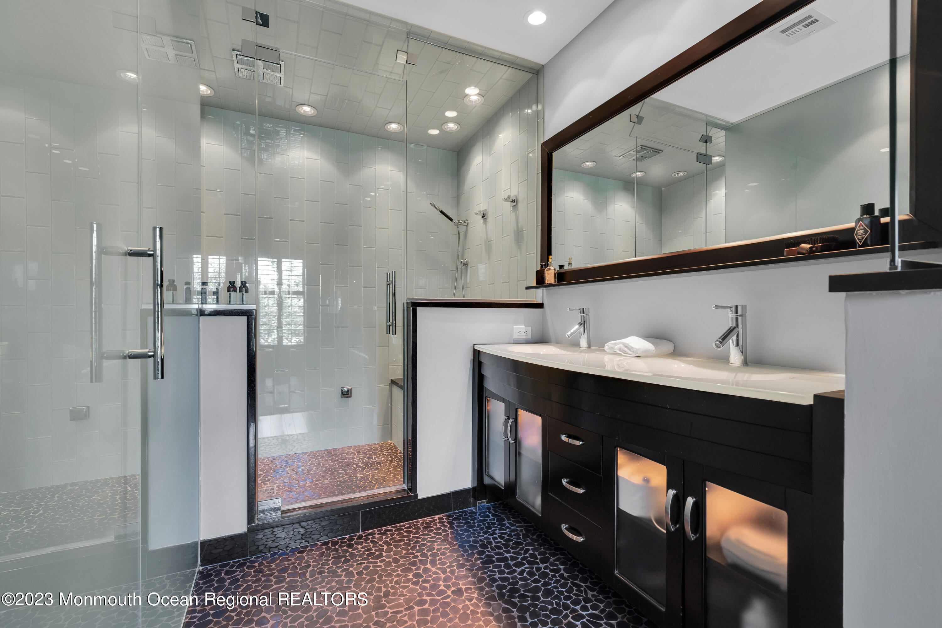 18 Wyckham Road Spring Lake Heights, NJ 07762 - Photo 36 of 74 a spacious bathroom with a double vanity sink a mirror and shower