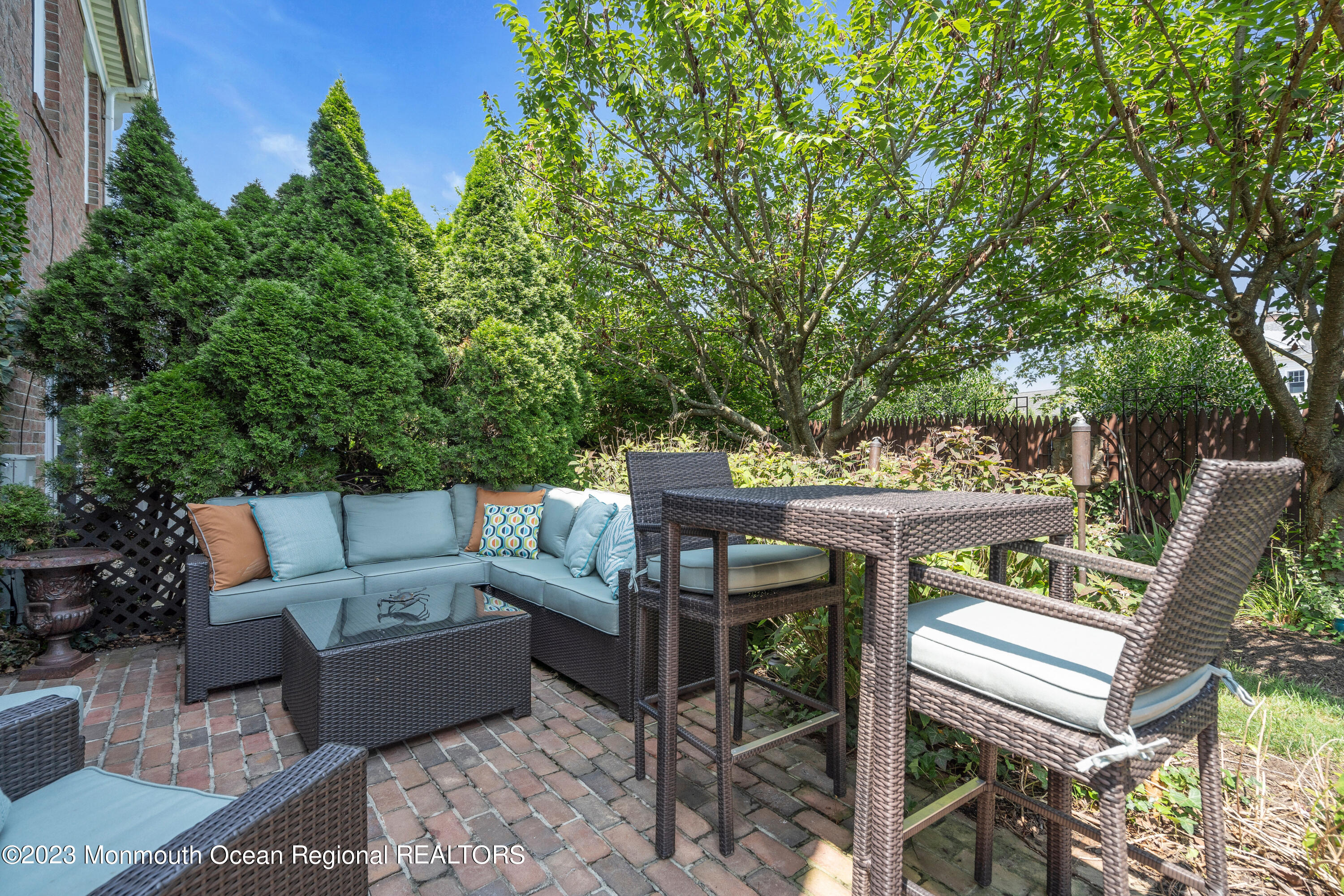 18 Wyckham Road Spring Lake Heights, NJ 07762 - Photo 64 of 74 a view of a patio with a dining table and chairs with wooden floor and fence