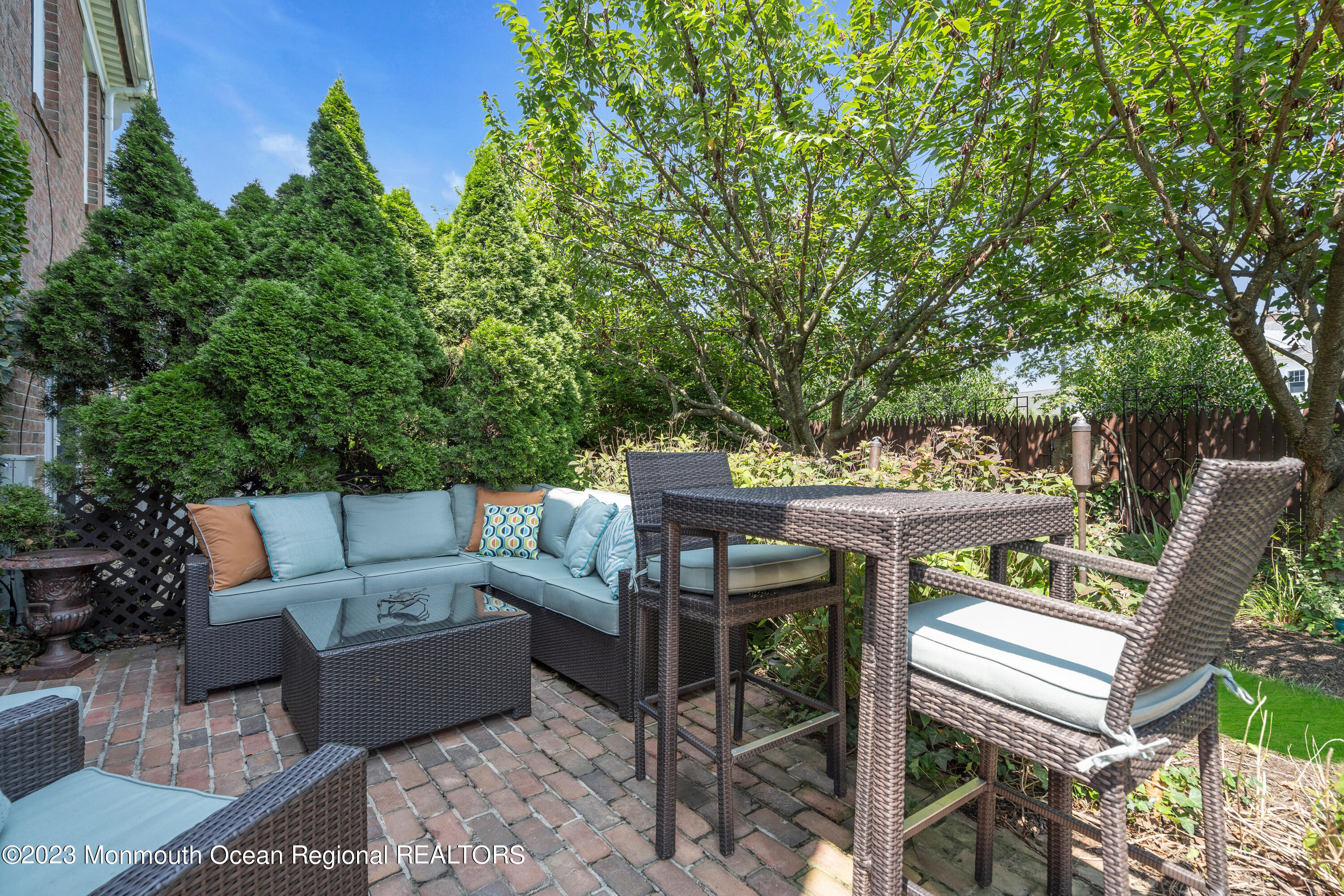 18 Wyckham Road Spring Lake Heights, NJ 07762 - Photo 68 of 74 a view of a patio with a dining table and chairs with wooden fence