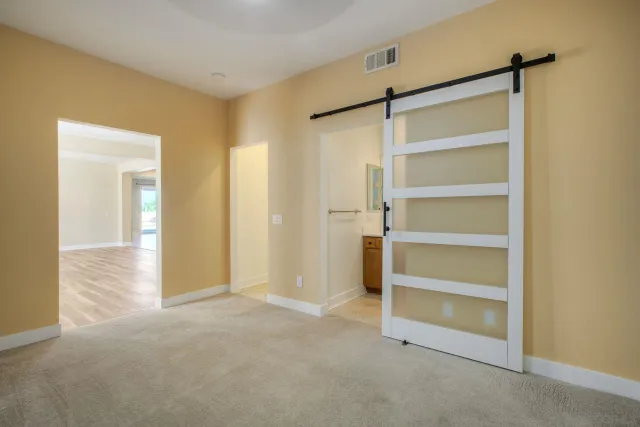 a view of an empty room with a closet