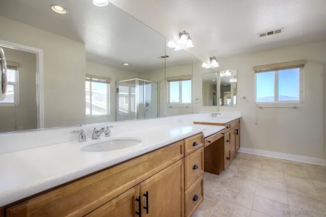 a bathroom with a sink vanity and mirror