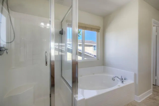 a bathroom with a bathtub and a shower