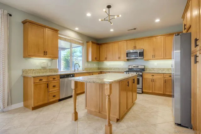 a kitchen with stainless steel appliances granite countertop a stove and a sink