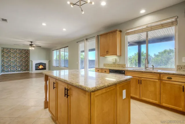 a kitchen with stainless steel appliances granite countertop sink stove and refrigerator