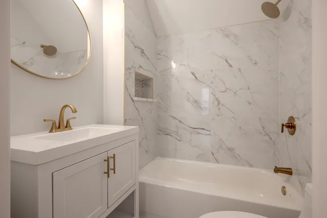 a bathroom with a sink a toilet and bathtub