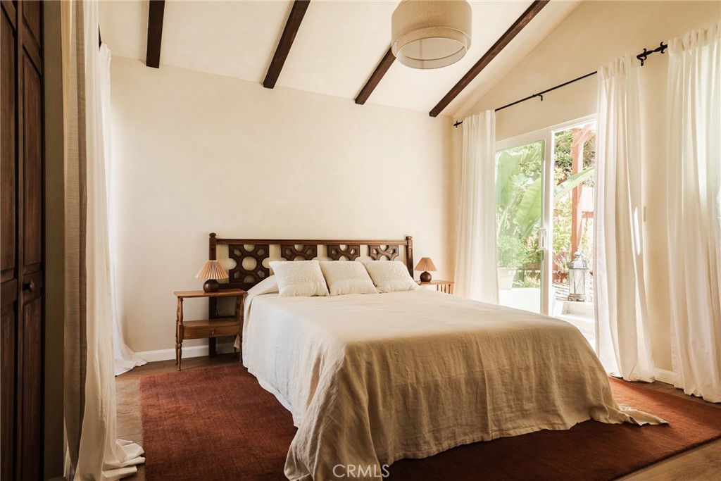 718 Sunnyhill Drive Los Angeles, CA 90065 - Photo 16 of 28 a bedroom with a bed and wooden floor