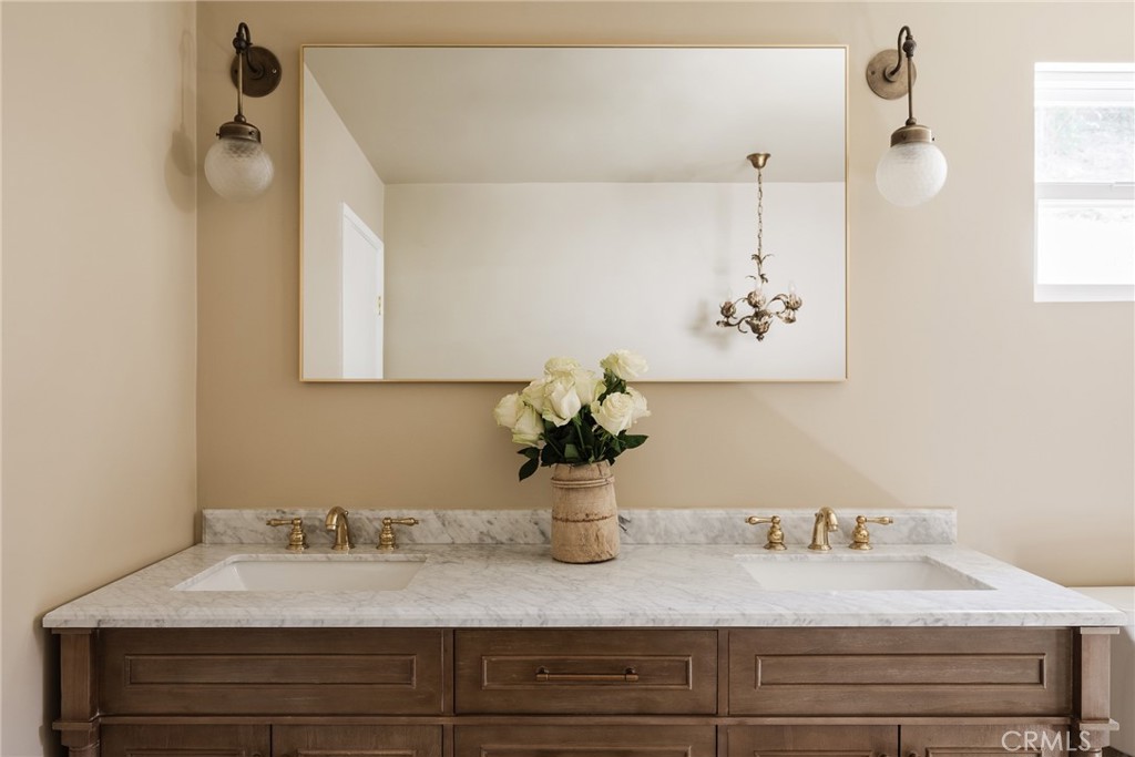 718 Sunnyhill Drive Los Angeles, CA 90065 - Photo 19 of 28 a bathroom with a sink and a mirror