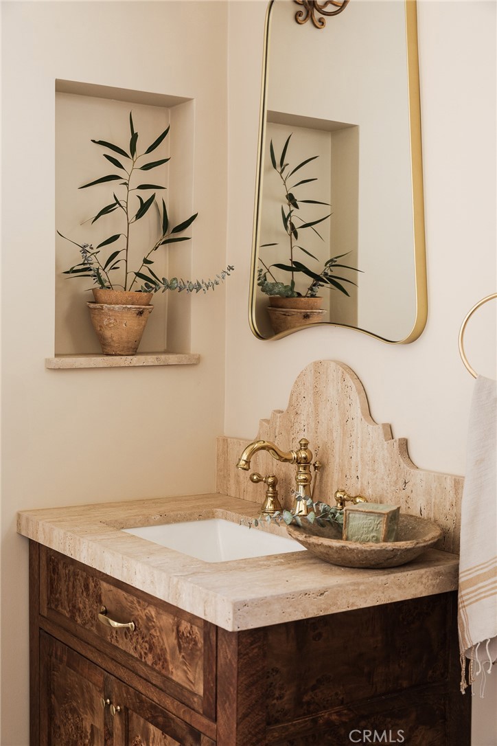 718 Sunnyhill Drive Los Angeles, CA 90065 - Photo 22 of 28 a bathroom with a sink and a mirror