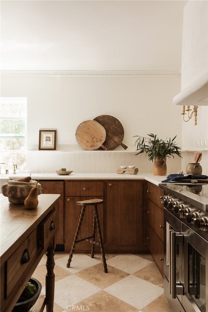 718 Sunnyhill Drive Los Angeles, CA 90065 - Photo 3 of 28 a kitchen with a sink a stove and wooden cabinets
