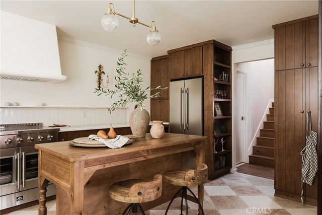 a kitchen with a refrigerator and a stove