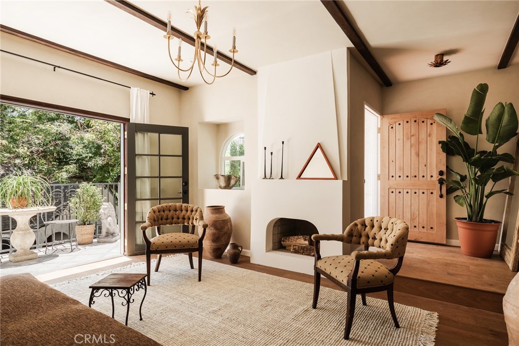718 Sunnyhill Drive Los Angeles, CA 90065 - Photo 10 of 28 a living room with furniture a fireplace and a floor to ceiling window