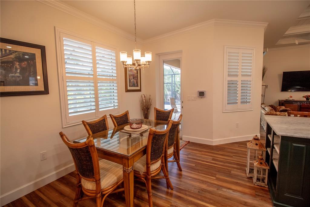 14056 Hydrangea Avenue Port Charlotte, FL 33953 - Photo 17 of 73 a view of a dining room with furniture window and wooden floor