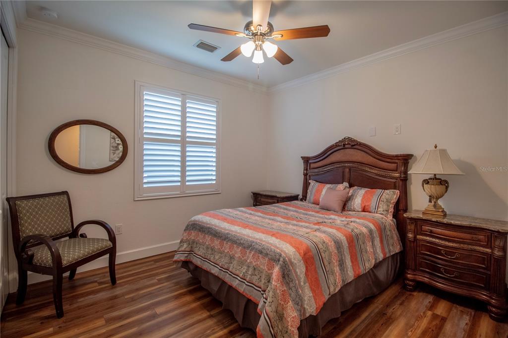 14056 Hydrangea Avenue Port Charlotte, FL 33953 - Photo 23 of 73 a bedroom with a bed a dresser and chair