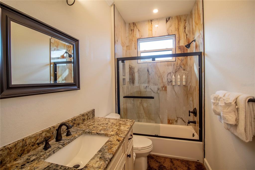 14056 Hydrangea Avenue Port Charlotte, FL 33953 - Photo 25 of 73 a bathroom with a sink toilet and shower