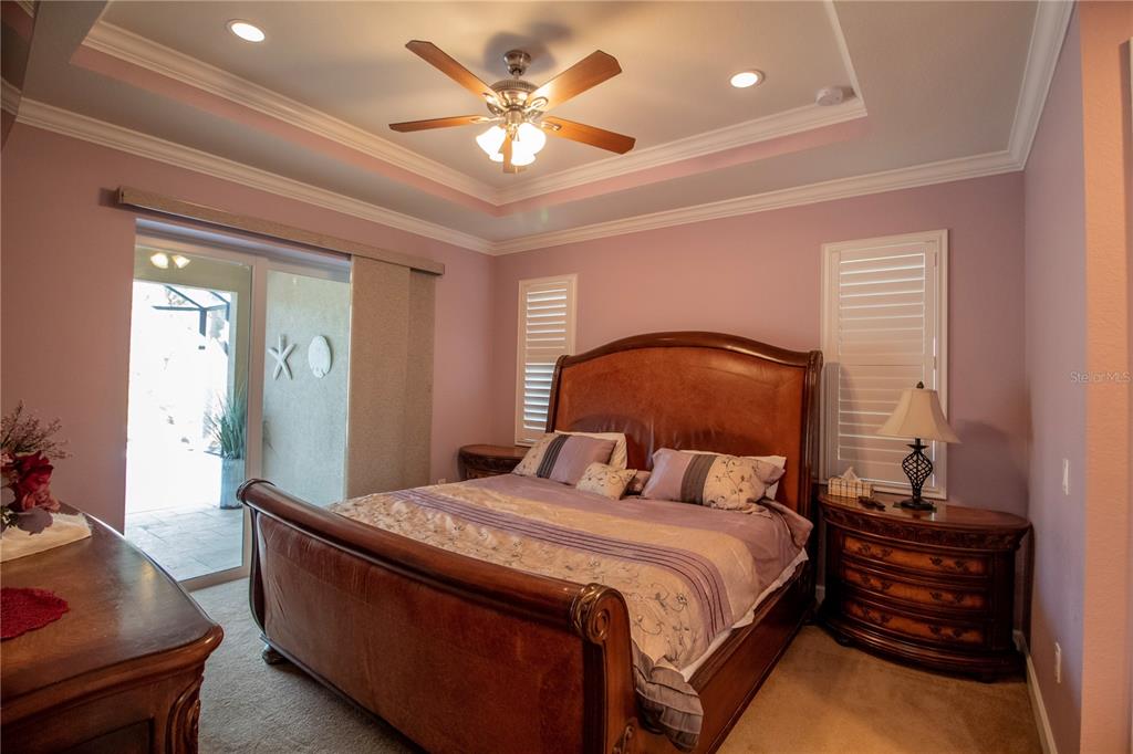14056 Hydrangea Avenue Port Charlotte, FL 33953 - Photo 27 of 73 a bedroom with a bed and a chandelier