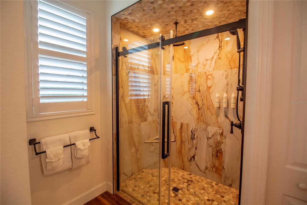 14056 Hydrangea Avenue Port Charlotte, FL 33953 - Photo 29 of 73 a bathroom with a shower and toilet
