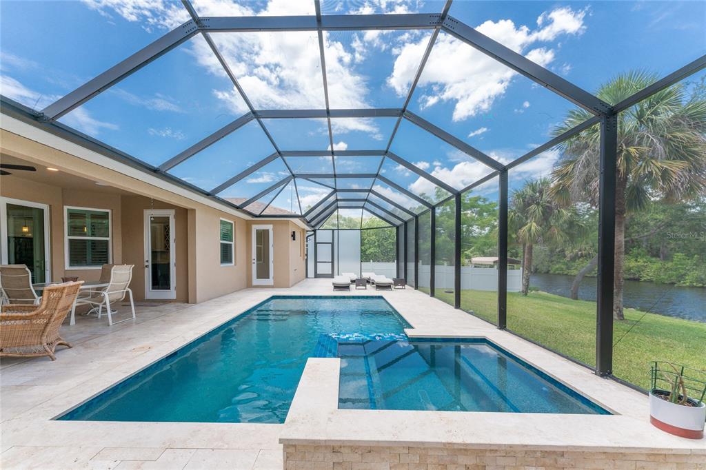14056 Hydrangea Avenue Port Charlotte, FL 33953 - Photo 3 of 73 a view of swimming pool with seating space