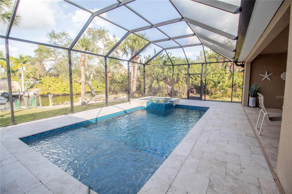 14056 Hydrangea Avenue Port Charlotte, FL 33953 - Photo 32 of 73 a view of an empty room with a floor to ceiling window next to a yard