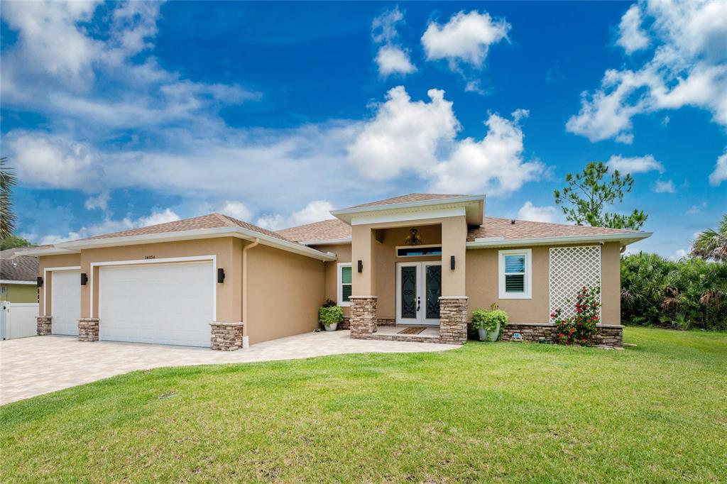 14056 Hydrangea Avenue Port Charlotte, FL 33953 - Photo 47 of 73 a front view of house with yard and outdoor seating
