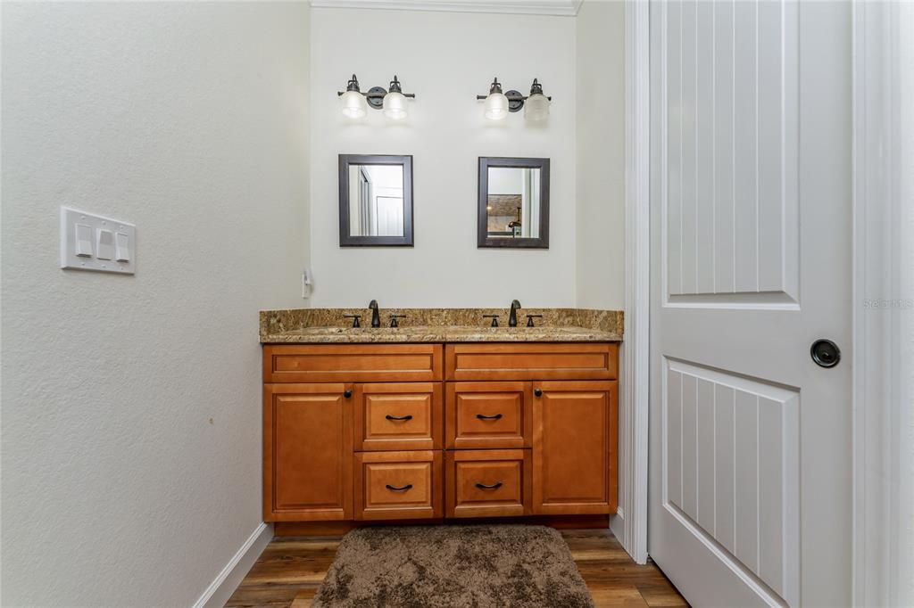 14056 Hydrangea Avenue Port Charlotte, FL 33953 - Photo 59 of 73 a bathroom with a granite countertop sink and a mirror
