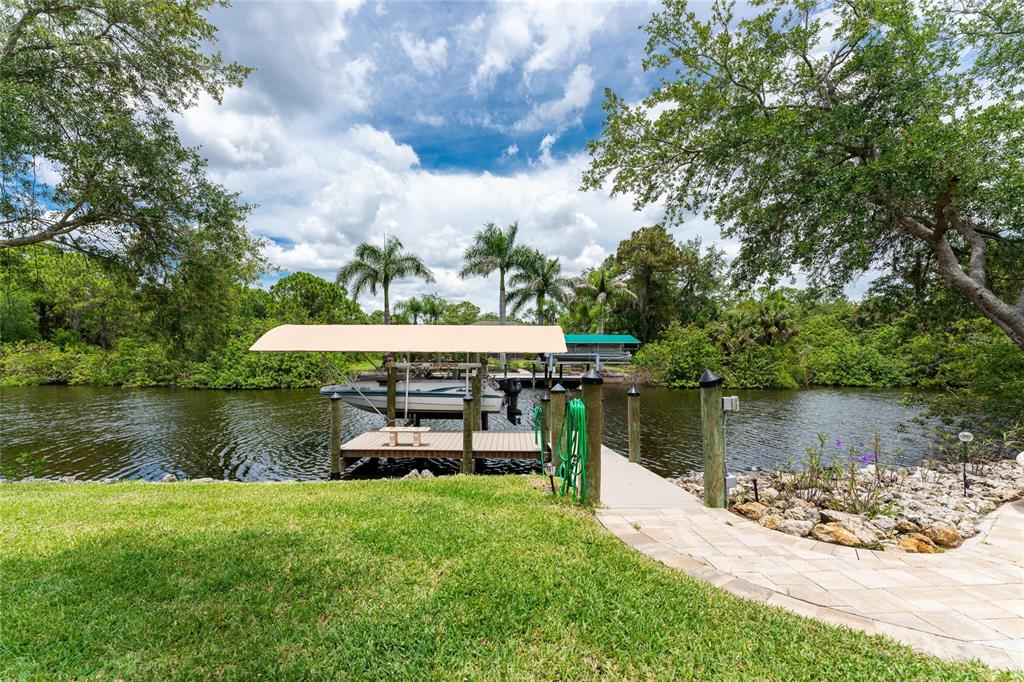 14056 Hydrangea Avenue Port Charlotte, FL 33953 - Photo 66 of 73 a view of a lake with a big yard and large trees
