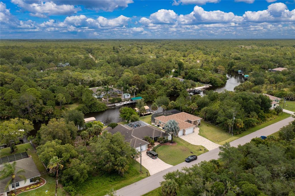 14056 Hydrangea Avenue Port Charlotte, FL 33953 - Photo 71 of 73 an aerial view of residential houses with outdoor space and lake view
