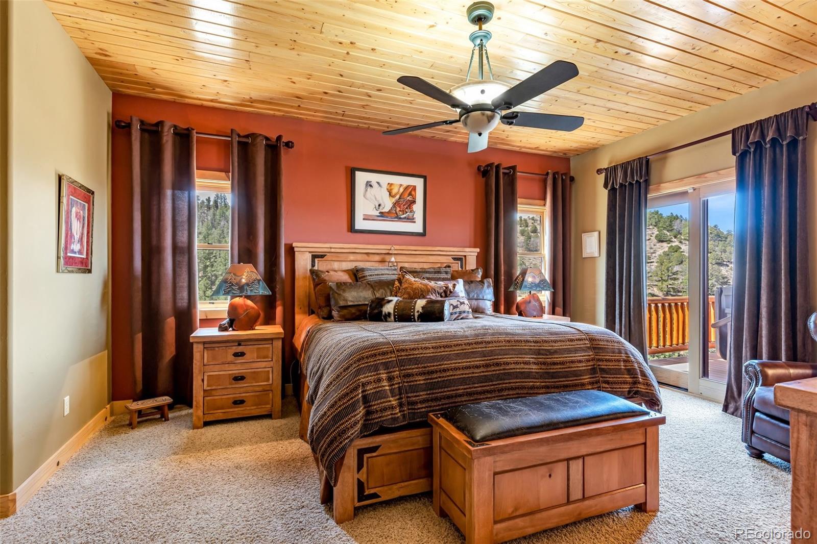 400 Ridge Road Westcliffe, CO 81252 - Photo 12 of 37 a bedroom with a bed and a chandelier